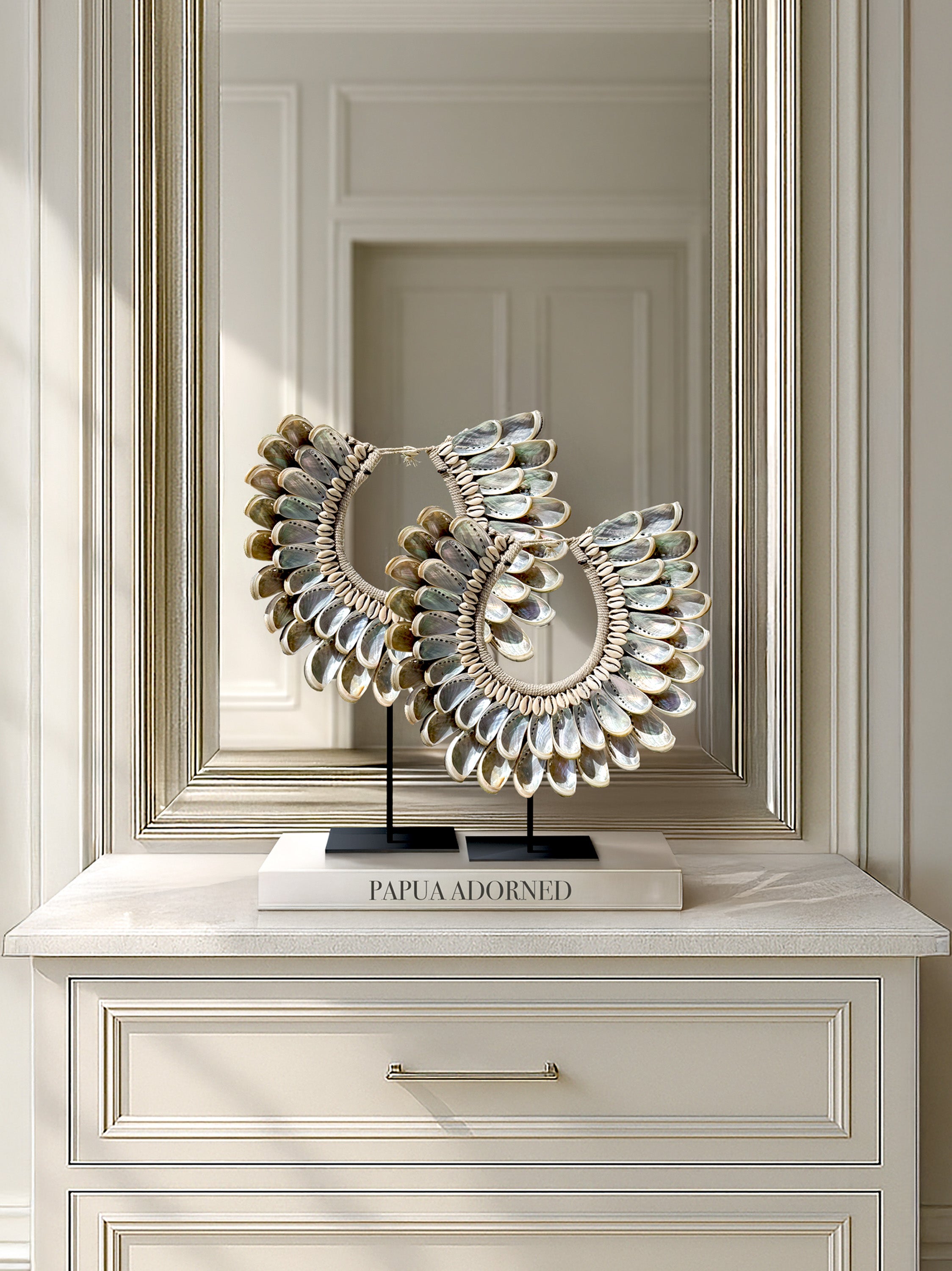 Discover handcrafted abalone shell necklaces from Papua—styled as luxury interior accents near Lago di Como. Add exotic texture and timeless charm to your curated living space.
