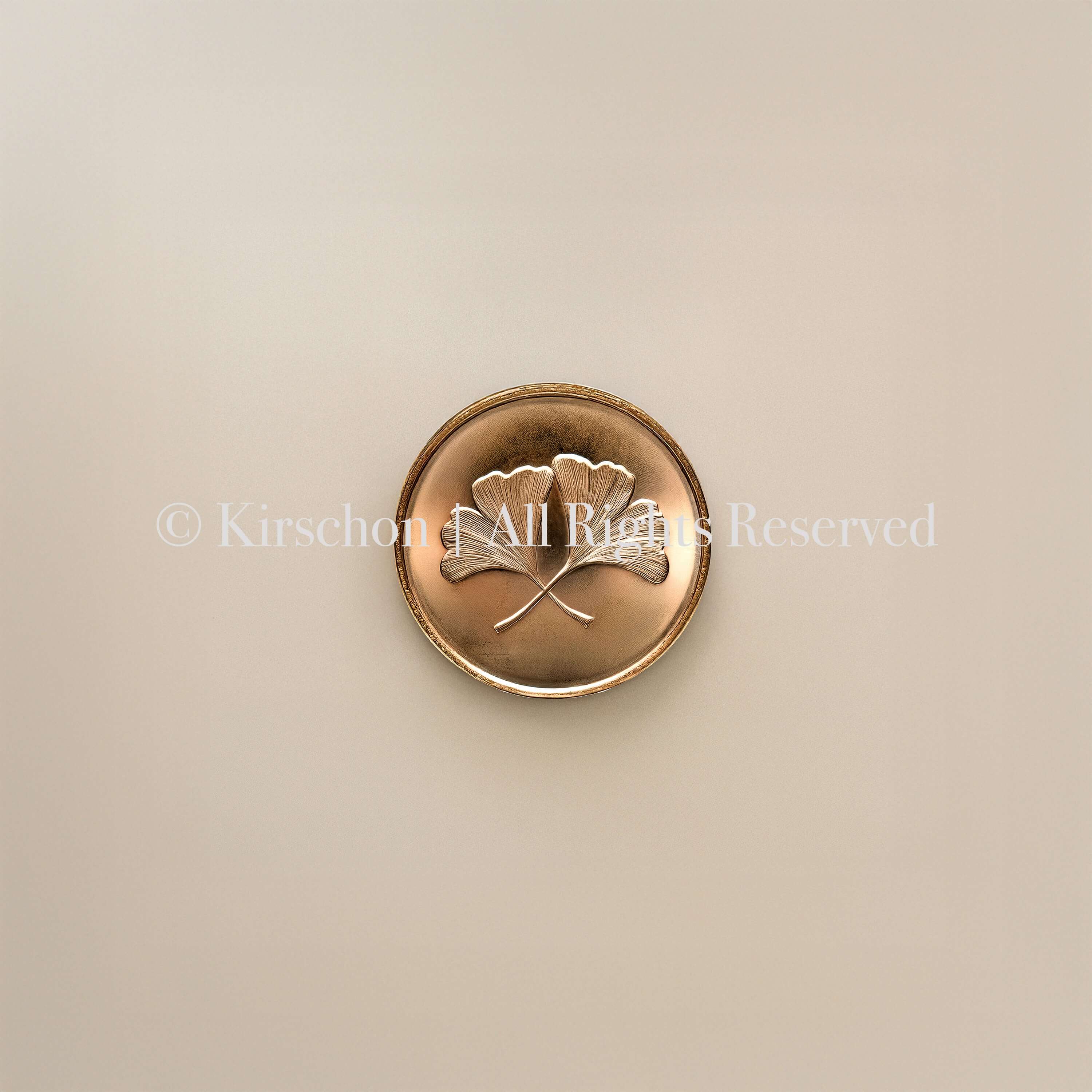 ANTIQUE CHINESE BRONZE COIN WITH GINKGO LEAF MOTIF ON ECRU BASE