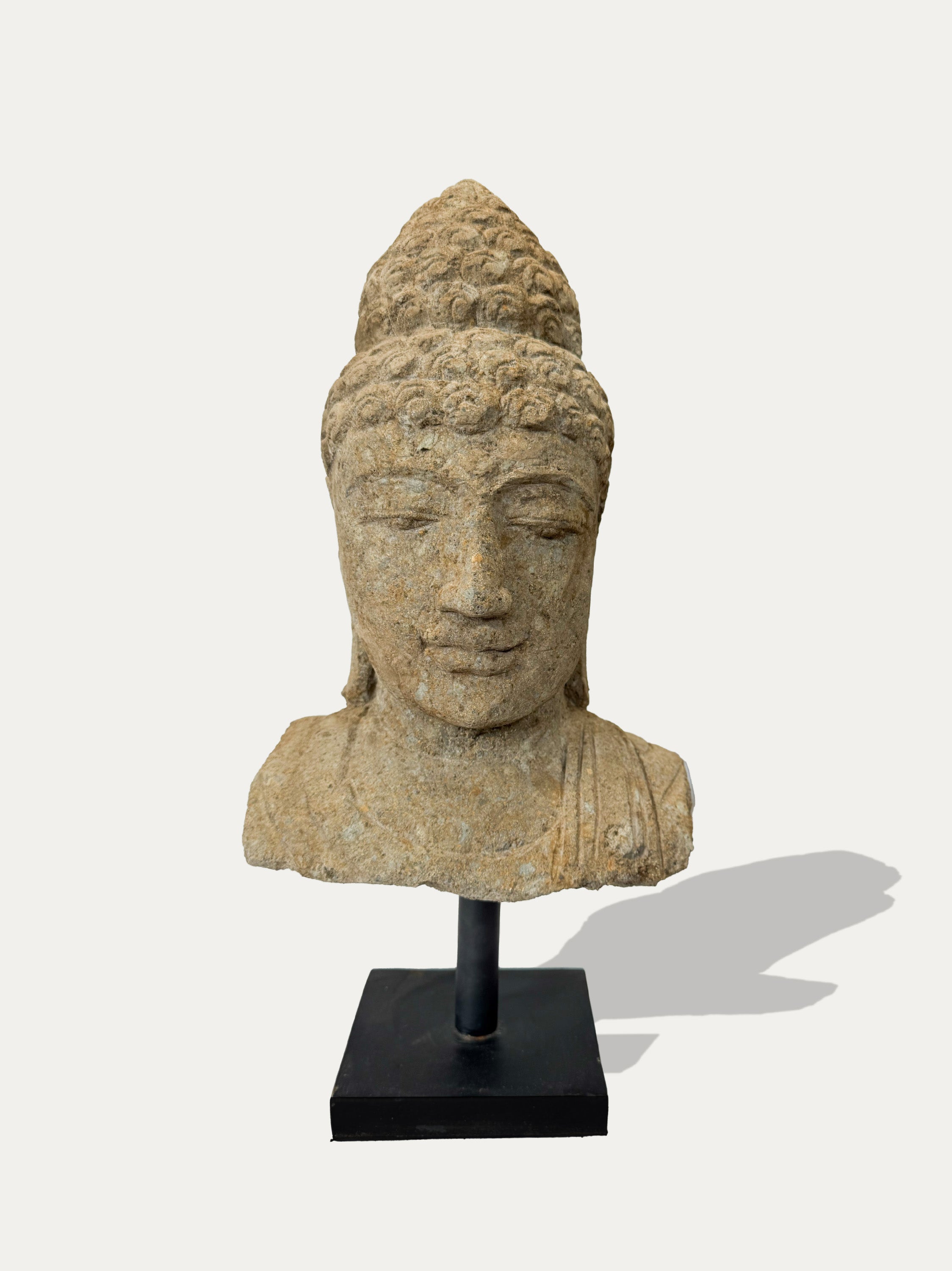 Java-carved Buddha head statue in stone – on display at Kirschon, near Lake Como