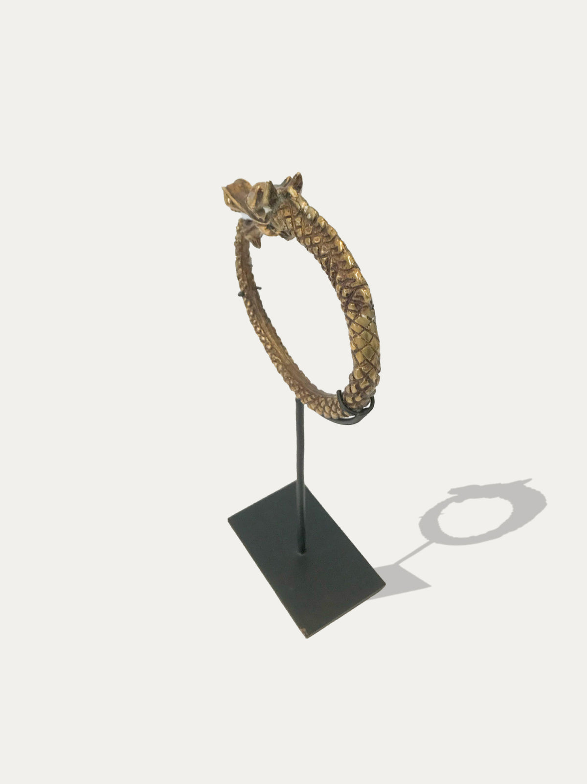 Borneo Naga dragon bangles and Sumatran brass cuff styled in a luxury interior on blackened metal supports