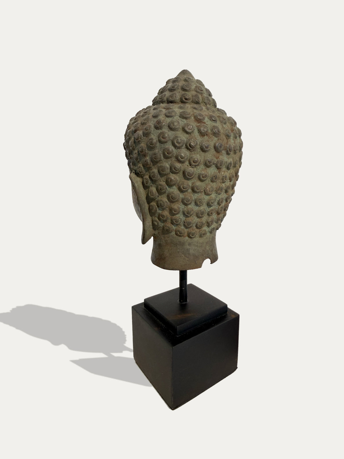 Bronze Buddha head from Java on black metal stand, Southeast Asian art
