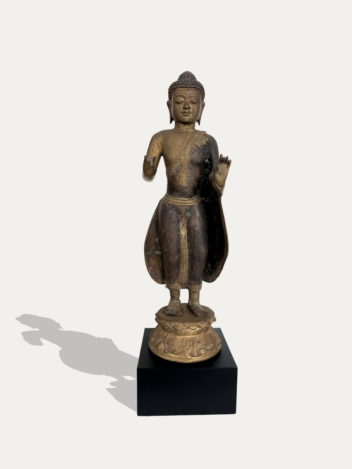 Vintage Javanese bronze standing Buddha statue from Indonesia