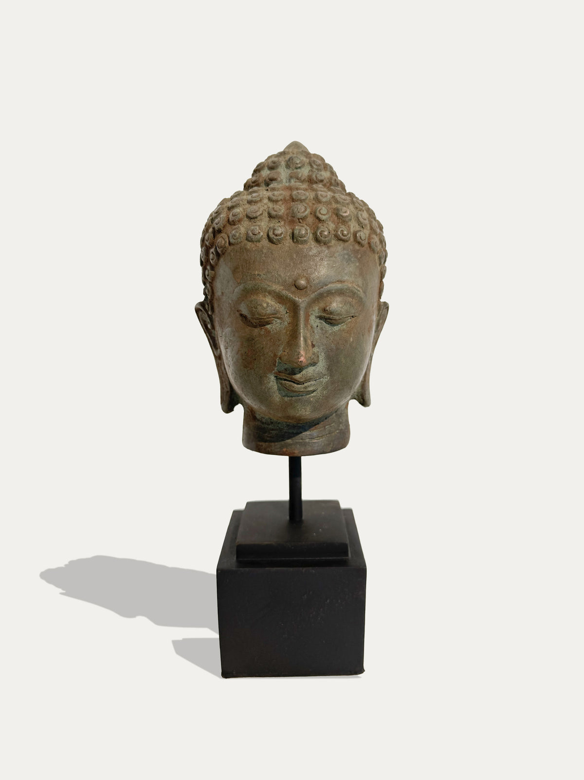 Vintage bronze Buddha head from Java, Indonesia, displayed as Asian art decor
