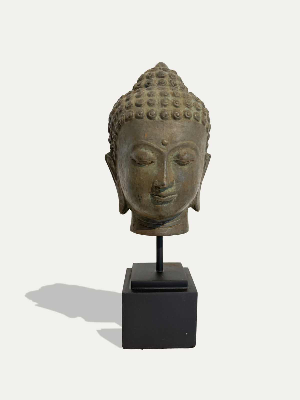 Vintage Javanese bronze Buddha head from Java, Indonesia, with aged patina
