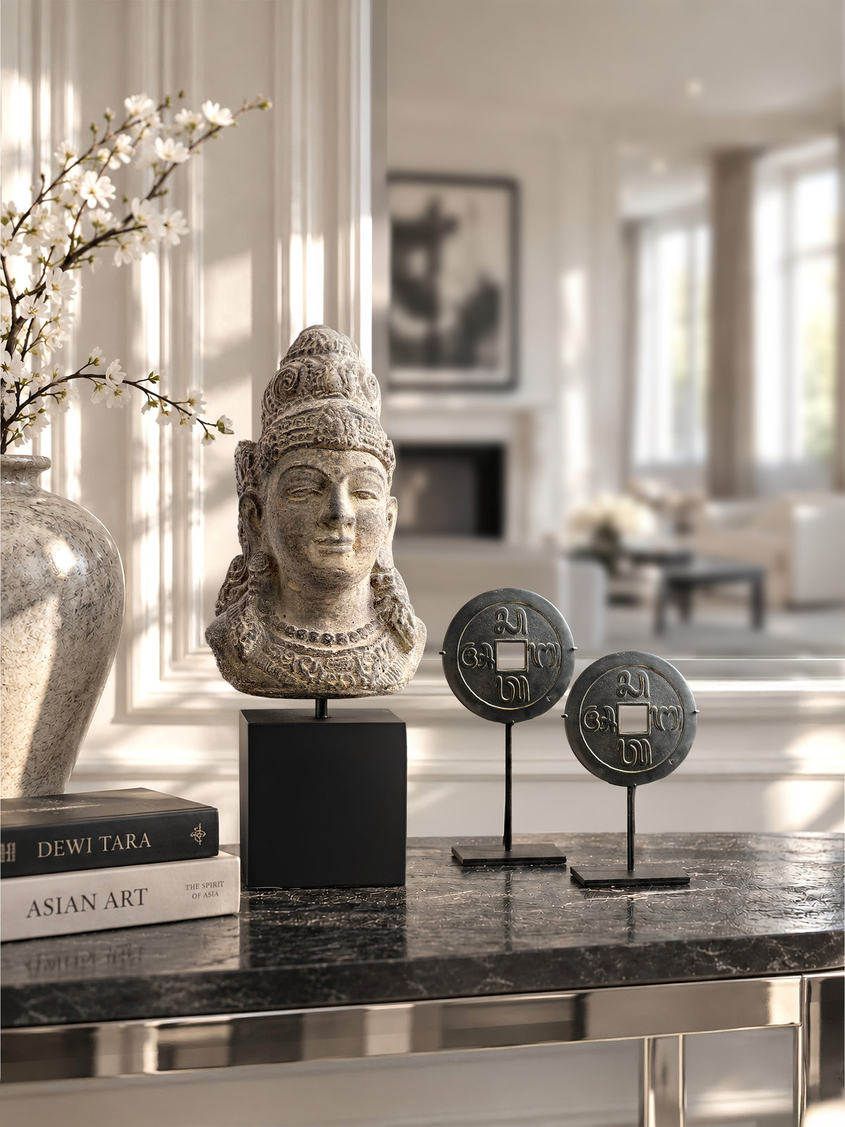 Dewi Tara stone bust with two sacred Pis Bolong Balinese coins on black metal stands