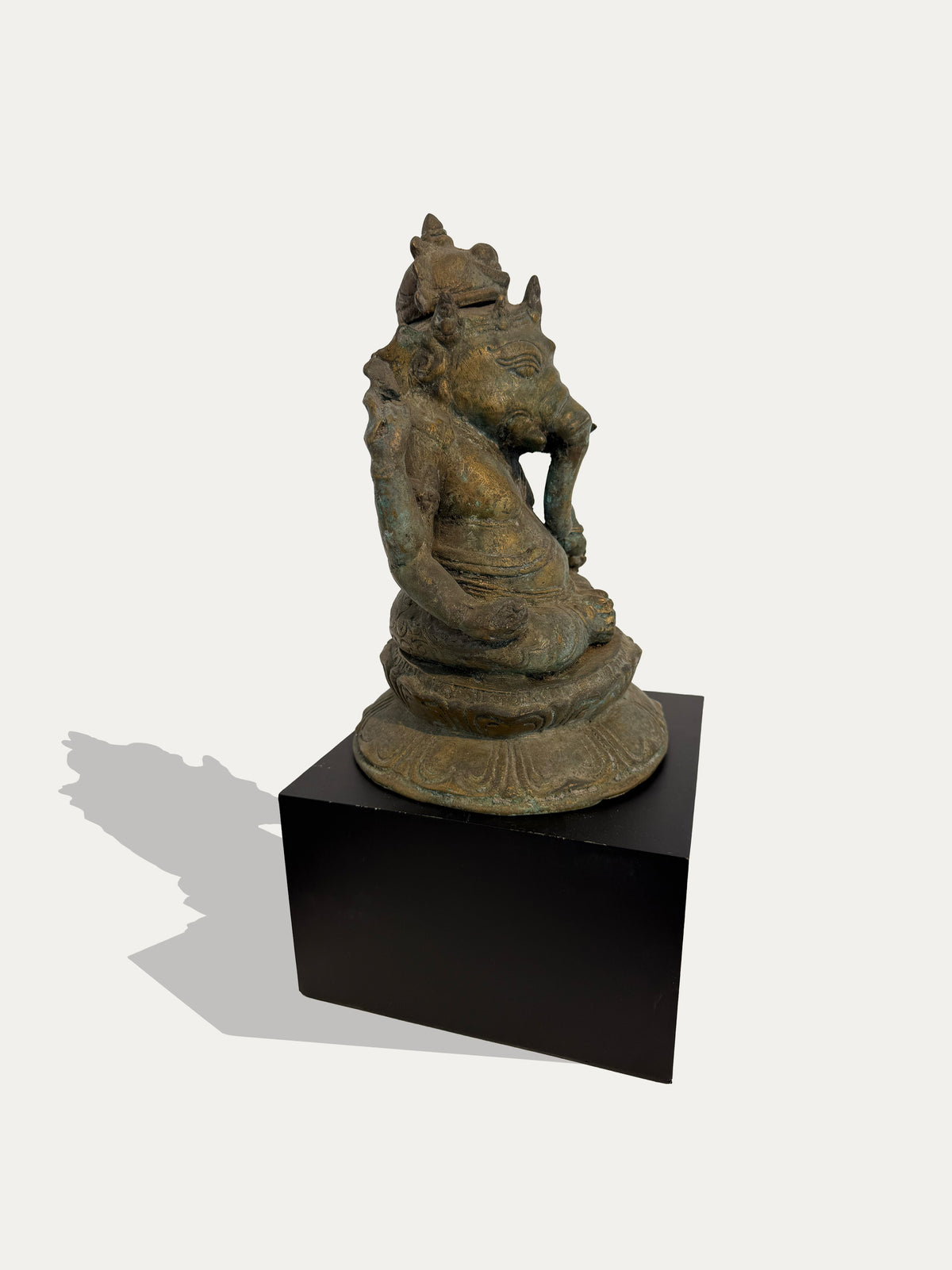 Javanese bronze Ganesha sculpture seated on a lotus base