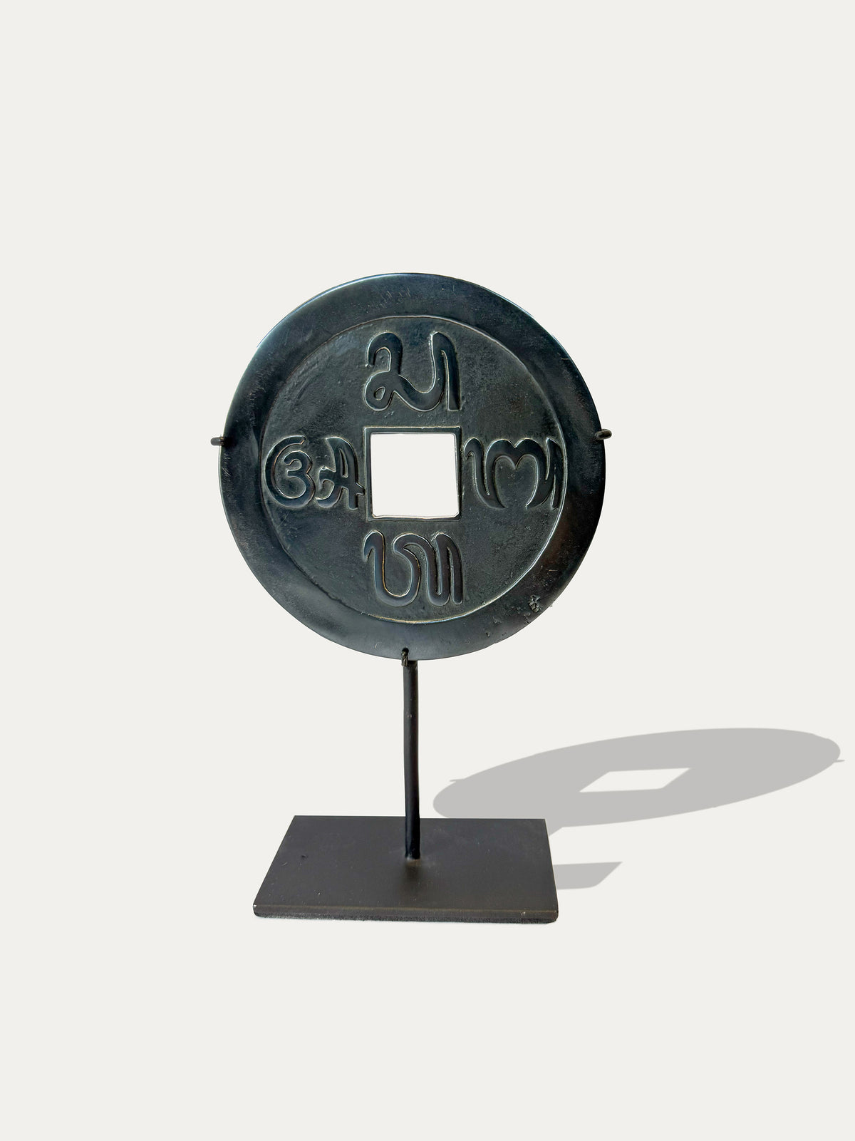 Balinese Pis Bolong sacred coins in Panca Datu alloy on black metal stands